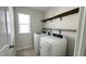Functional laundry room with window for natural light and shelving at 49 W Copenhaver Dr, Clayton, NC 27527