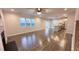 Open-concept living room featuring hard surface floors, fireplace, ample natural light, and an eat-in kitchen at 49 W Copenhaver Dr, Clayton, NC 27527