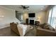 Cozy living room with a fireplace, comfortable seating, and large windows for natural light at 49 W Copenhaver Dr, Clayton, NC 27527