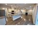 Open-concept living space seamlessly connects the kitchen and living room with a fireplace at 49 W Copenhaver Dr, Clayton, NC 27527