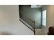 Elegant staircase featuring a wood and iron railing and neutral wall colors at 49 W Copenhaver Dr, Clayton, NC 27527