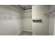 Spacious walk-in closet with multiple levels of shelving and carpeted floor at 49 W Copenhaver Dr, Clayton, NC 27527