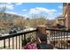 Charming balcony view with wrought iron railings, potted plants, and a comfortable outdoor chair at 500 John Haywood Way # 103, Raleigh, NC 27604