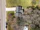 Aerial view of home with driveway, lush lawn, and mature trees at 5108 Melbourne Rd, Raleigh, NC 27606