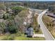 Aerial view of home near highway and surrounding lush, tree-filled neighborhood at 5108 Melbourne Rd, Raleigh, NC 27606