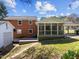 Backyard with a garage, screened porch, brick patio, and a covered carport at 5108 Melbourne Rd, Raleigh, NC 27606