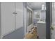 Cozy blue bathroom features a shower/tub combo, white vanity, and built-in linen closet at 5108 Melbourne Rd, Raleigh, NC 27606