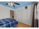 Bright bedroom with blue ceiling and white closet doors, features hardwood floors and natural light at 5108 Melbourne Rd, Raleigh, NC 27606