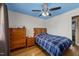 Bedroom with light blue ceiling, hardwood floors, light walls, and built-in dresser at 5108 Melbourne Rd, Raleigh, NC 27606