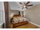 Spacious bedroom featuring hardwood floors, two windows, a ceiling fan, and neutral paint at 5108 Melbourne Rd, Raleigh, NC 27606