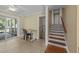Cozy dining area with neutral decor, ceiling fan, sliding glass doors to a deck, and stairs to the second floor at 5108 Melbourne Rd, Raleigh, NC 27606