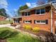 Charming brick home with manicured lawn and lush landscaping in a peaceful neighborhood at 5108 Melbourne Rd, Raleigh, NC 27606