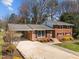 Beautiful red brick home with an attached carport and landscaped front yard at 5108 Melbourne Rd, Raleigh, NC 27606