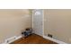 Foyer showcasing hardwood floors, shoe rack, coat hooks, and decorative door at 5108 Melbourne Rd, Raleigh, NC 27606