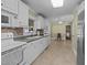 Well-lit kitchen with white cabinetry, modern appliances, and view into dining room at 5108 Melbourne Rd, Raleigh, NC 27606