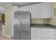 Modern kitchen with stainless steel refrigerator and white cabinets at 5108 Melbourne Rd, Raleigh, NC 27606