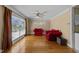 Cozy living room featuring hardwood floors, large window, and comfortable furniture at 5108 Melbourne Rd, Raleigh, NC 27606