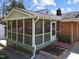 View of screened porch with green railings and steps leading to backyard at 5108 Melbourne Rd, Raleigh, NC 27606