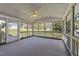 Large screened-in porch with ceiling fan and outdoor views at 5108 Melbourne Rd, Raleigh, NC 27606