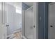 A tiled shower with glass door inside of a clean, bright, blue bathroom at 5108 Melbourne Rd, Raleigh, NC 27606