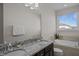 Bathroom with double sinks, granite countertops, soaking tub, and a large window for natural light at 517 Aronia Dr, Hillsborough, NC 27278