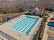 Large community pool featuring multiple lanes, pergola, and clubhouse with parking in a neighborhood setting at 517 Aronia Dr, Hillsborough, NC 27278