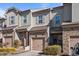 Charming townhome exterior with stone accents, single car garage and professional landscaping at 517 Aronia Dr, Hillsborough, NC 27278