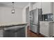 Modern kitchen features stainless steel appliances, granite countertops, and dark tile backsplash at 517 Aronia Dr, Hillsborough, NC 27278