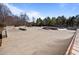 Concrete skate park with various ramps and rails, adjacent to mulch, and with blue sky in background at 517 Aronia Dr, Hillsborough, NC 27278