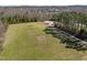 Aerial view of a soccer field with two goals surrounded by trees and a path in a neighborhood community at 517 Aronia Dr, Hillsborough, NC 27278