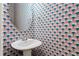 Stylish half-bathroom features blue and red patterned wallpaper and a pedestal sink at 525 Fallon Grove Way, Raleigh, NC 27608