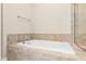 Bathroom showcasing soaking tub with tiled surround near glass shower at 525 Fallon Grove Way, Raleigh, NC 27608