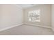 Cozy bedroom with neutral carpet and a bright window at 525 Fallon Grove Way, Raleigh, NC 27608