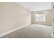 Bedroom with neutral walls, carpet, and a large window at 525 Fallon Grove Way, Raleigh, NC 27608