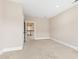 Bedroom with neutral walls and carpet leading to the hallway at 525 Fallon Grove Way, Raleigh, NC 27608