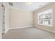 Bedroom featuring plush carpet and a window offering natural light at 525 Fallon Grove Way, Raleigh, NC 27608