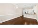 Bright dining area flowing into a kitchen with white cabinets and stainless steel appliances at 525 Fallon Grove Way, Raleigh, NC 27608