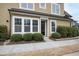 Charming entryway with manicured bushes, a black front door, and a well-lit sidewalk at 525 Fallon Grove Way, Raleigh, NC 27608