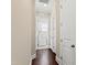 Hallway featuring multiple closets and entry to a laundry room at 525 Fallon Grove Way, Raleigh, NC 27608