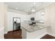 Modern kitchen with white cabinets, granite countertops, and stainless steel appliances at 525 Fallon Grove Way, Raleigh, NC 27608