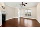 Bright living room featuring hardwood floors, fireplace, and a ceiling fan at 525 Fallon Grove Way, Raleigh, NC 27608