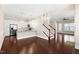 Spacious living room with hardwood floors, leading to a staircase and an open-concept kitchen at 525 Fallon Grove Way, Raleigh, NC 27608