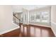 Open living area with hardwood floors, staircase, and ample natural light from large windows at 525 Fallon Grove Way, Raleigh, NC 27608