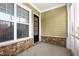Covered porch with stone accents and large window at 525 Fallon Grove Way, Raleigh, NC 27608