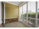 Covered porch with stone accents and plantation shutters at 525 Fallon Grove Way, Raleigh, NC 27608