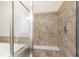Close up of a tiled shower featuring a built in bench and glass door at 525 Fallon Grove Way, Raleigh, NC 27608
