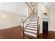 Elegant staircase with white risers, wood treads, and a fireplace in the adjacent living area at 525 Fallon Grove Way, Raleigh, NC 27608