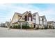 Charming multi-colored townhomes with landscaped yards and sidewalks on a sunny street corner at 525 Fallon Grove Way, Raleigh, NC 27608