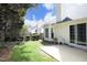 Backyard featuring a sliding glass door leading to a concrete patio and grassy area, and a wooden fence at 5513 Edgebury Rd, Raleigh, NC 27613