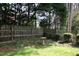 Backyard featuring a wooden fence and a bird bath among the greenery at 5513 Edgebury Rd, Raleigh, NC 27613